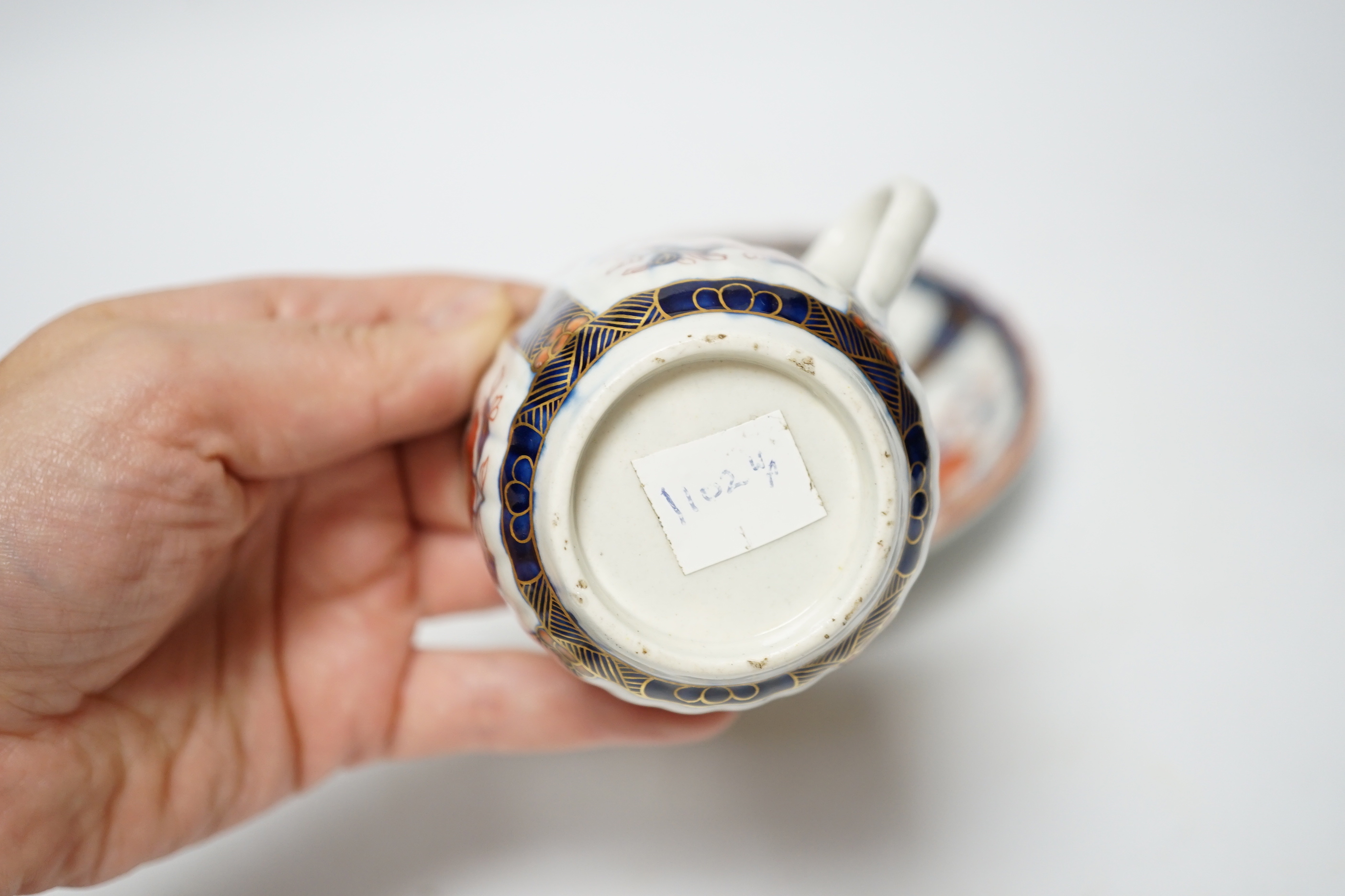 A Worcester ‘low Chelsea ewer’ milk jug, c.1770 and a Worcester Japan pattern coffee cup and saucer, c.1780, jug 6.5cm